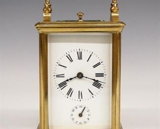 French Carriage Clock - An early 20th century French carriage clock.  8-day time, strike and alarm movement with repeat button, platform escapement and porcelain dial with Roman numerals subsidiary alarm indicator dial.  Brass case with fold down handle and beveled glasses.  Minor wear, wound tight when cataloged.  5" high.  ESTIMATE $200-300


