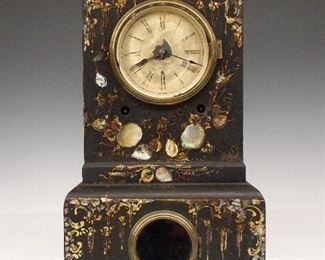 J C Brown Iron Shelf Clock - A 19th century J. C. Brown Iron shelf clock.  8-day time and strike movement with painted metal dial and Roman numerals.  Cast Iron case with Black painted finish, Mother-of-Pearl decoration and gilded detail.  Some case wear, dial wear, running when cataloged.  13 3/4" high.  ESTIMATE $200-300

