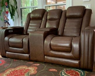Two sets of reclining leather media chars with built in storage.