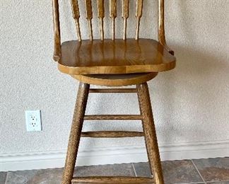 One of Four Oak Swivel Bar Stools