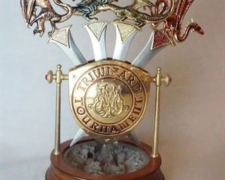 1043 HARRY POTTER THE NOBLE COLLECTION TRIWIZARD TOURNAMENT LETTER OPENER SET IN DISPLAY STAND. STAND ALONE IS APP. 5 IN H, 4 1/2 IN W