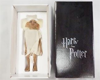 1073 HARRY POTTER TONNER 10 IN DOBBY DOLL W/ BASE IN ORIGINAL BOX.