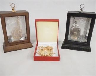 1074 LOT OF THREE HARRY POTTER NECKLACES, TWO COME IN NICE DISPLAY CASES. DISPLAY CASES ARE 4 3/4 IN X 3 3/4 IN, 1 3/4 IN DEEP.