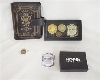 1075 LOT OF HARRY POTTER GRINGOTTS BANK COLLECTABLES, LOT INCLUDES A NECKLACE BACK OF PENDANT IS MARKED STERLING SILVER, 3 COINS IN DISPLAY CASE & GRINGOTTS SAVINGS BOOK.