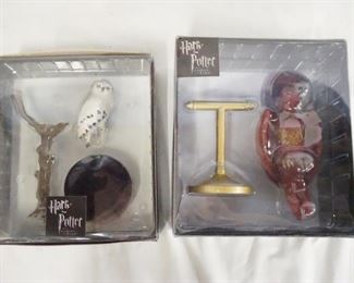1129 LOT OF TWO HARRY POTTER TONNER FIGURES; HEDWIG & FAWKES. THE PERCH FOR FAWKES FIGURE HAS BEEN REPAIRED. BOTH COME W/ ORIGINAL BOXES