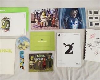 1140 LOT OF MOVIE MEMORABILIA FROM THE FIRST & SECOND SHREK FILMS. LOT INCLUDES A SIGNED SCRIPT & 2 SIGNED PRINTS, A DIGITAL PRESS KIT, 12 35 MM SLIDES, PRODUCTION INFO ETC.