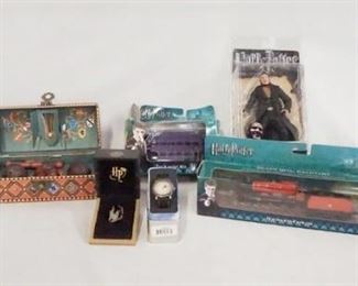 1177 LOT OF MISC. HARRY POTTER COLLECTABLES LOT INCLUDES A NOBLE COLLECTION QUIDDITCH CHEST, NECA TRAIN & CAR/BUS MODEL, FENRIR GREYWOLF ACTION FIGURE, A SORCERERS STONE NECKLACE, A WATCH & A CAULDRON CANDLE HOLDER.