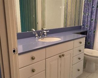 White cabinets with purple countertops, sink & faucet, mirror & light fixtures, 56” wide