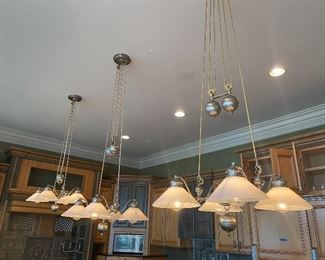There are 3 matching brushed nickel weighted height adjustable (on a pulley) light fixtures. 
