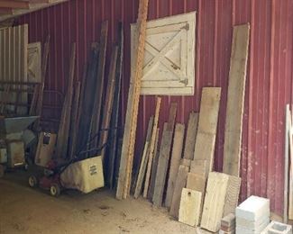 Assorted lumber of various sizes and lawn mower