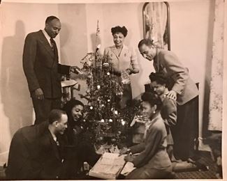 Christmas in Bronzeville. Family gathers around a feather Christmas tree.