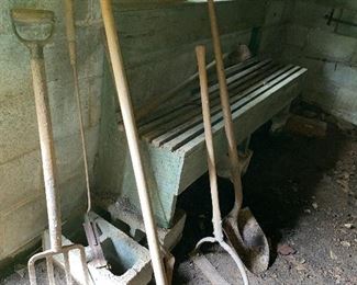 Old green bench and, garden tools