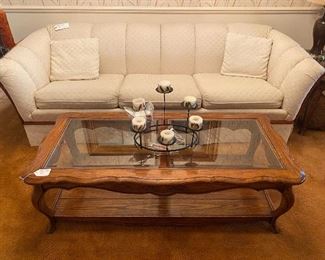 Oak Coffee Table with Glass Top. Matches Side tables. Elegant Upholstered Sofa with Wooden Trim.