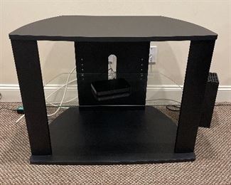 Entertainment style black shelving unit. Two shelves. One glass. Great for TV DVR DVD or stereo