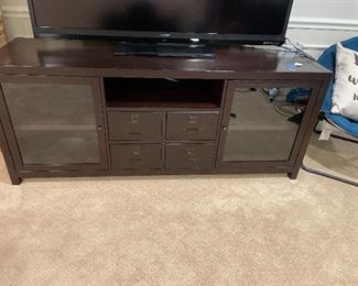 Pottery Barn consol with four shelves and 4 drawers. RHYS.  Perfect for television stereo systems. 65”L. X. 20”D. X. 27” H