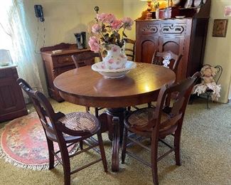 Victorian round pedestal dining table with four late 1800 period chairs