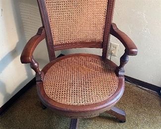 Antique walnut swivel cane chair