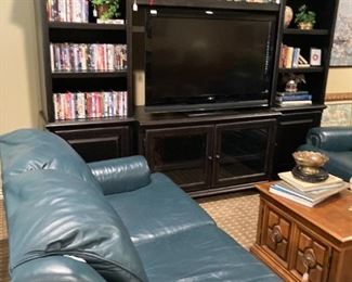 Great freestanding black TV wall unit filled with movies. Get the popcorn!!!
