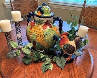 The table has a Lazy Susan in the center; rooster and other decorative items.