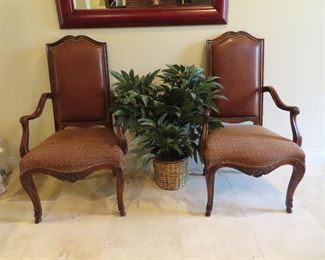 Pair of Henredon leather and upholstery arm chairs. Artificial plants flow throughout the house.