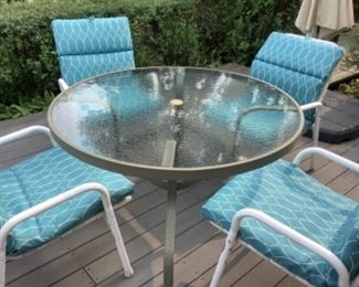 Outdoor patio set with turquoise chair pads.  48” round.  Presale $125