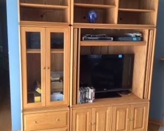 In four pieces, this shelving unit measures 72” total width and 85” tall.  The first section on left is 24” wide and tv section is 48” w. The modular pieces on top are 20” tall.  Presale..sold in sections.  Glass door section is $65, tv section is $50.  Shelving above is$15 and $25