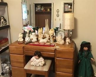 Mid century modern dressing table with large mirror and bench. Christmas figures on dresser.  Two cute dolls.