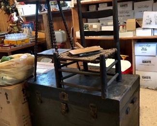 Large old trunk, small tall table and wagon chair.