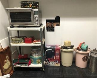 Breville toaster oven, vintage  metal rolling cart, Lean Mean grilling machine,ice cream makers, wooden trays, cutting boards and vintage tins.