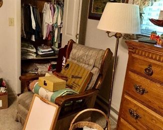 Vintage rocking chair, floor lamp, Kincaid Solid Wood Furniture chest of drawers, basket with scarfs, lap tray, women clothing. 