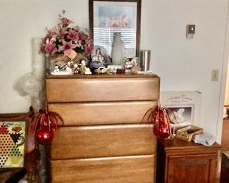 Midcentury modern chest of drawers. Bric-a brac on top of chest. Straight back chair with vintage chinese checker board, small oak table.