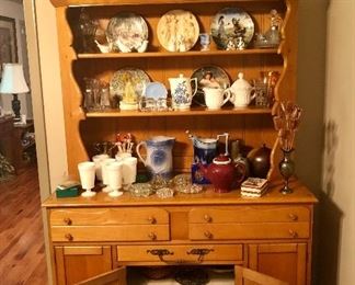 Farmhouse hutch load with stoneware, milk glass, collectors plates, brass and crystal.