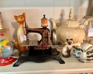 Antique miniature toy sewing machine made in Germany 'Hansel and Gretel Witch', Made in USA tin bank , tall cat candle, Takahashi cat tape dispenser. 