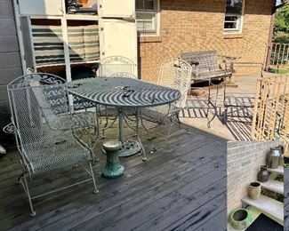 Vintage wrought iron set: table ( w umbrella stand)/ 4 chairs, wood glider, chairs …
Cushions in cabinet!