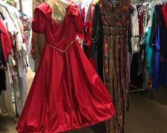 A red taffeta dress with cape and hoop is only one of the handmade Gowns!
