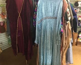 Red velvet with metallic gold trim and a pale blue metallic gown from the 1980s.