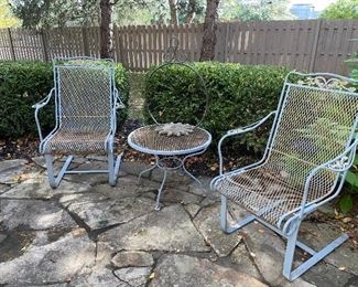 Couple wrought iron chairs and table