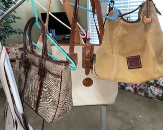 Several designer purses including Dooney & Burke