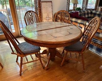 Wood and tile kitchen table with 1 leaf and 6 chairs (only 4 are shown here)......
