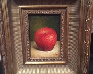 Framed painting of an apple.