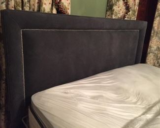 Lovely gray tufted King-sized bed.