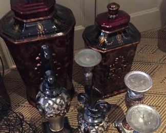 Candlestick holders and decorative canisters.
