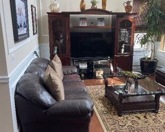 The entertainment center is for sale ,. End cabinets are not attached .
300
Leather sofa has some fading on the cushions.. Comes with a matching love seat which is also fading on the cushions
250 for the pair 