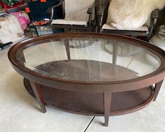 Oval glass top wooden base coffee table 