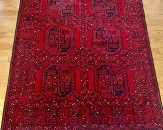 $450    Bokhara red rug, 66" L x 44" W.