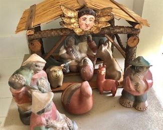 $180  Creche with pottery pieces thatched roof structure .  11.5" H, 15.5" W, 10" D.  Tallest figure 7.5" H, 4" W, 3" D.  