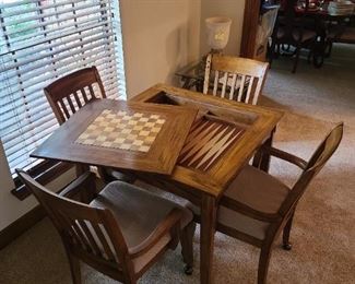 SURPRISE!!! Square wood slat table with easy lift off top = game table ~ backgammon and checkers or chess
Includes 4 chairs that roll