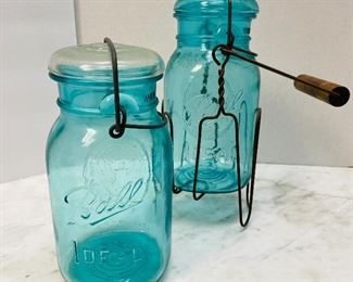 #25 - NOW $15 was $30 • Lot 2 antique ball jars  • One with carrying stand 