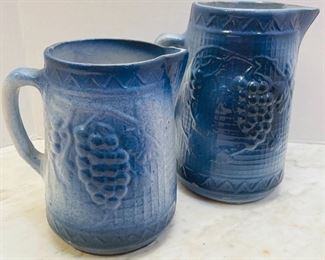 #57- NOW $45 was $90 • set Early American stoneware grapes on grid • 9high • 8high set of 2 pitcher