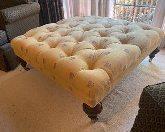 A large tufted 'cocktail table' size ottoman 